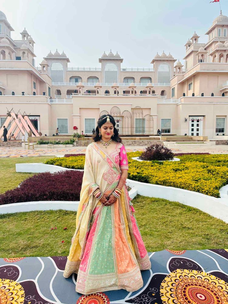 A bride in a pastel lehenga from Hello Beauty, photographed outdoors